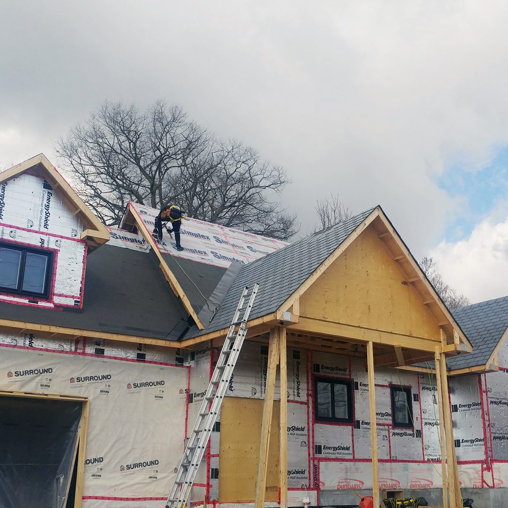 Installer Performing Roofing Services For New Construction Home